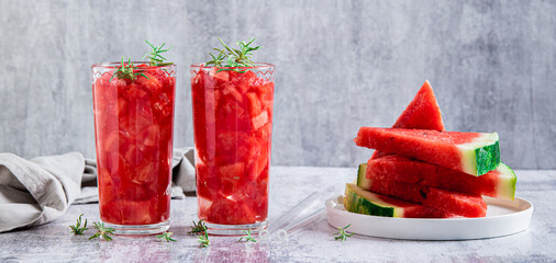 Detox summer drink with watermelon and rosemary in glasses on table web banner