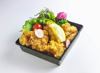 Japanese Karaage Fried Chicken Bento Box with Fresh Salad on White Background