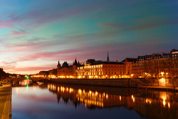 Conciergerie building located along of the Seine river and the center of Paris under a early sunrise lights. It was successively King's palace the prison and justice hall in French history.