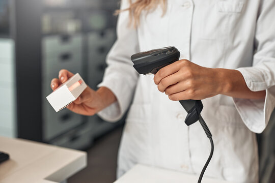 Scanning barcode on a medicine package at pharmacy counter