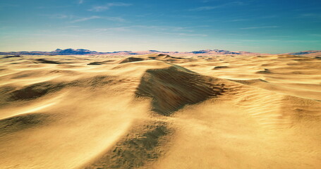 Expansive golden sand dunes stretch endlessly, their gentle curves shaped by the wind. A clear blue sky above enhances the tranquil desert landscape during midday.