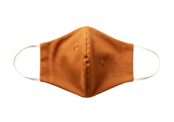 Orange fabric face mask with floral embroidery isolated, reusable cloth covering for protection and personal care