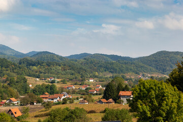Rural landscape in the mountainous part of the Balkans with scattered houses on the mountain slopes