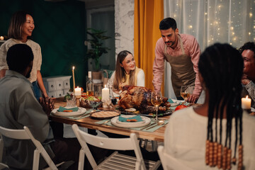 Friends celebrating thanksgiving enjoying roasted turkey