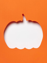 Orange pumpkin cutout with flying black bats.