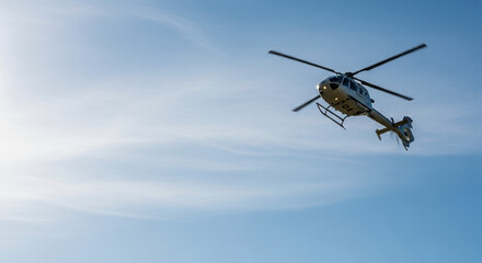 Fototapeta premium Helicopter in sky against a bright, clear sky, one helicopter flies with its rotors spinning, creating visual drama. Dramatic helicopter aviation photography with rotorcraft against azure background.