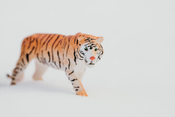 One toy tiger on a snowy background.