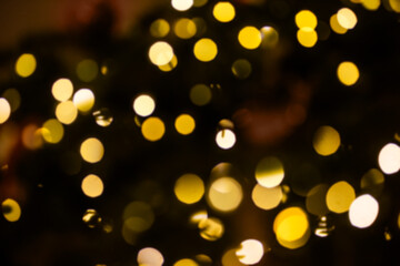 Blurred golden and white circular bokeh lights glowing against a dark background, creating a warm, festive, dreamy holiday celebration backdrop for cards and design use