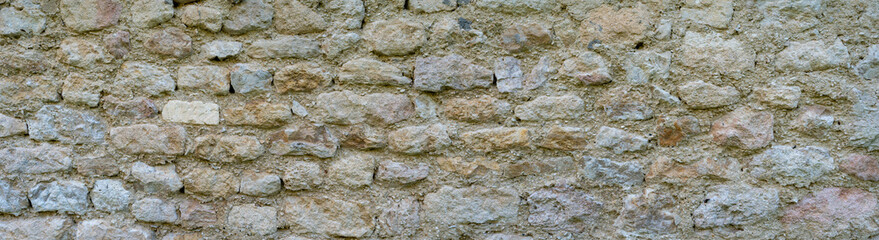 Old rustic stone wall with weathered texture