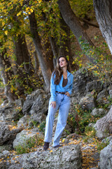 Full body portrait of a young beautiful woman in blue jeans