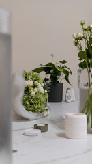A white and green bouquet lies on the counter in a flower shop