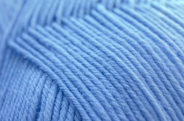 Close-up Texture of Blue Wool Thread. Winter yarn in a ball background. Handicraft concept, hobby, online knitting course.