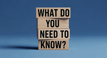 Wooden blocks stacked with the question what do you need to know against a blue background