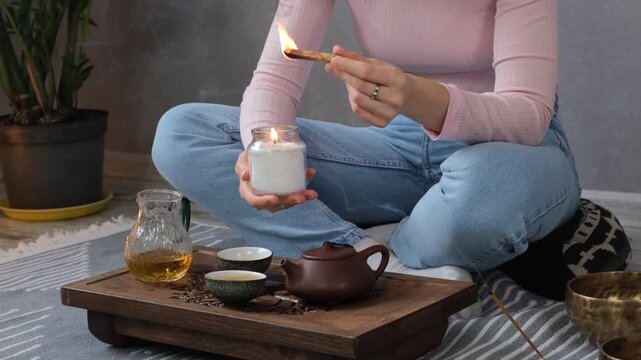 Woman lighting incense for meditation and spiritual practice