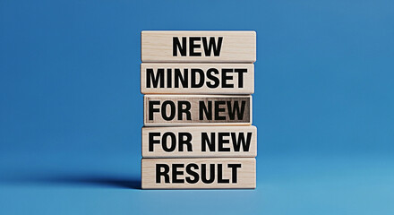 Wooden blocks stacked with motivational message new mindset for new result on a blue background
