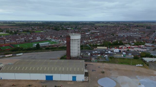 Aerial drone view of the water tower in Goole UK. Historic infrastructure overlooking busy shipping port on River Trent, import export  