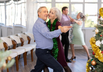 Elderly man and elderly woman dance couple tango dance in studio