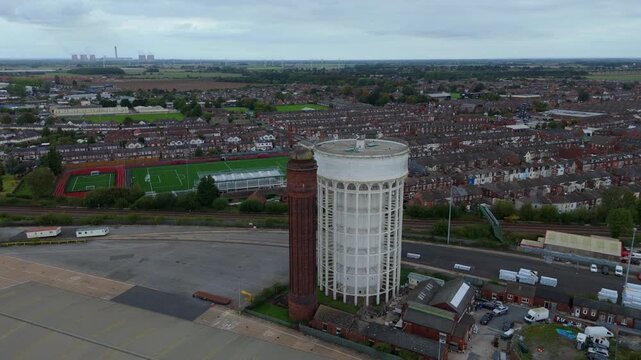 Aerial drone view of the water tower in Goole UK. Historic infrastructure overlooking busy shipping port on River Trent, import export  
