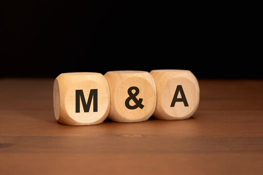 The letters M and A written on wood cubes. business concept.