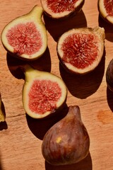 Close-up of cut ripe figs on a chopping board. Organic and healthy snack with vivid color and soft texture.