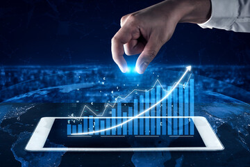A hand interacts with a digital graph displayed on a tablet screen, symbolizing financial growth and global connectivity in today data-driven world. Impute