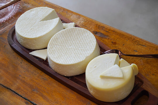 Varied Minas Gerais cheeses on rustic table