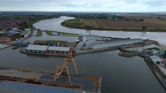 Aerial drone view of busy shipping port, industrial buildings and wharfs for loading and unloading cargo ships and tankers near Goole, United Kingdom