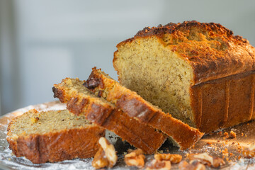Homemade banana bread loaf with slices and walnuts