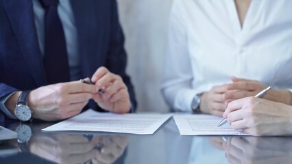 Diverse business people discussing contract terms before signing the agreement. Teamwork of lawyers and businesspeople