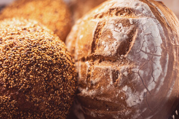 Artisanal bread loaves with diverse toppings displayed in a cozy bakery setting