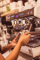 Crafting a perfect espresso shot at a bustling coffee shop in the afternoon