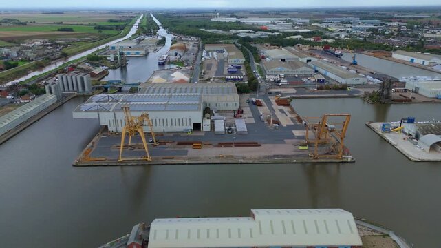 Aerial drone view of busy shipping port, industrial buildings and wharfs for loading and unloading cargo ships and tankers near Goole, United Kingdom