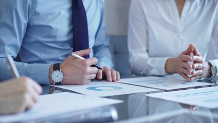 Business people are reviewing a financial results and discussing the terms of the agreement. Teamwork and planning