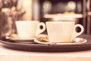 Enjoying freshly brewed coffee in elegant white cups on a tray at a cozy cafe during a warm afternoon