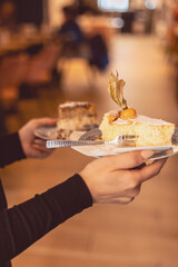 Waiter serves delicious cake slices at cozy cafe with inviting atmosphere