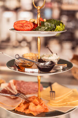 Delicious variety of meats, cheeses, and fresh vegetables served in a cozy cafe setting