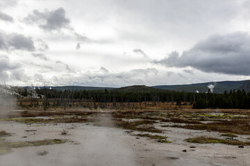 Explore the dramatic landscape of Yellowstone with geothermal features, perfect for travel blogs,...
