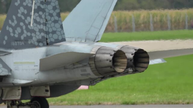 F-18 fighter jet preparing for takeoff at airfield on a sunny day