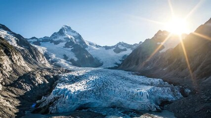 Wide-Angle Time-Lapse of Mountain Glaciers Shrinking with Glowing Sun Flare