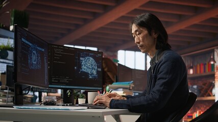 CTO manager in AI startup drinking coffee while coding applications in programming languages. Chief...