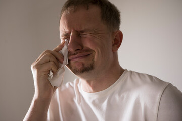Frustrated guy crying and panicking, holding hands on head and screaming distressed