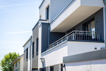 Modern apartment building with spacious balconies under clear blue sky