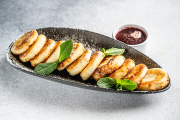 Homemade syrniki with berry sauce