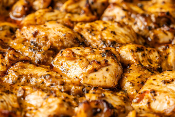Golden grilled chicken pieces closeup