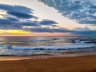 Seaside Sunrise Under a Cloud-Filled Sky