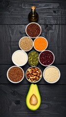 Tree of seeds, nuts, and oil on dark wood