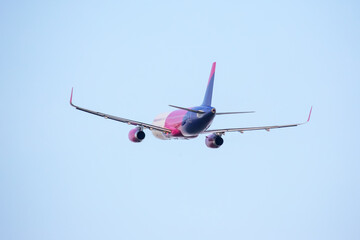 Commercial airplane in flight against clear blue sky during daytime travel