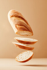 Baguette loaf with diagonal cuts and soft crumb, and sliced pieces