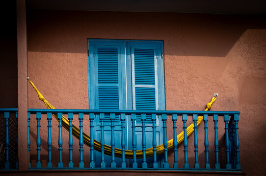 Smiling Balcony With Blue Shutters And Yellow Hammock