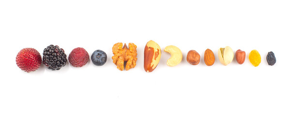 Colorful arrangement of various fruits and nuts displayed on a white background